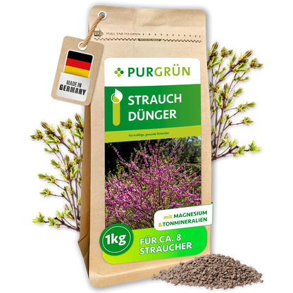 Purgrün Strauchdünger, 1 kg, im wiederverschließbaren Standbeutel mit Blütenstrauch-Motiv und feinem Granulat.