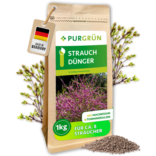 Purgrün Strauchdünger, 1 kg, im wiederverschließbaren Standbeutel mit Blütenstrauch-Motiv und feinem Granulat.